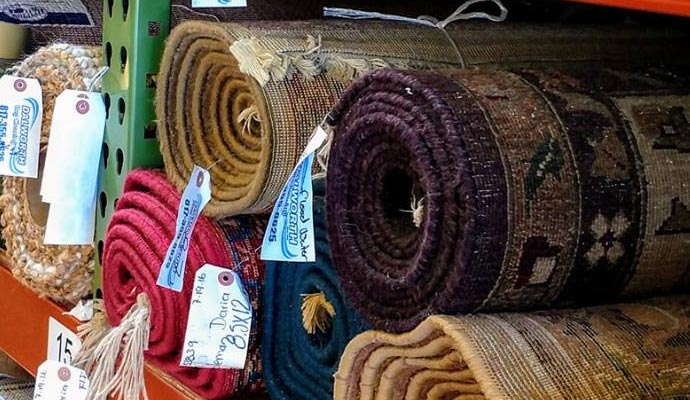 A side by side comparison of a navajo rug before cleaning and after cleaning