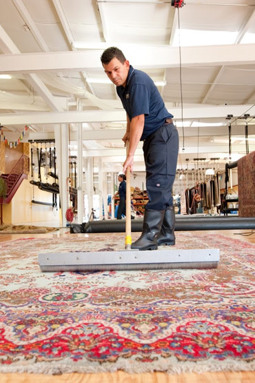 Dalworth Crew Member Cleaning Rug