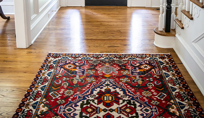 Rug placed on a wooden floor in a home entryway