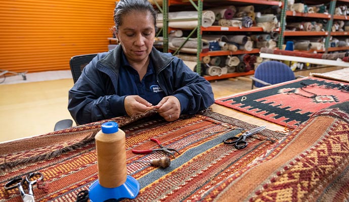 worker repairing rug