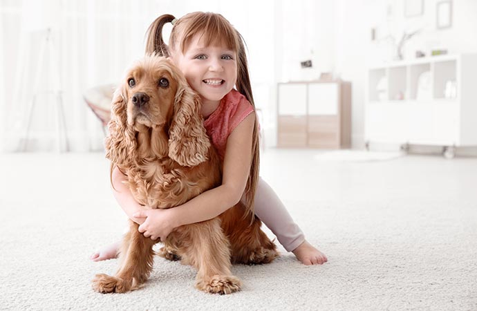 A smiling pet owner affectionately adoring her beloved pet.
