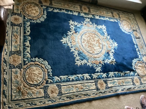 Professional cleaning and fiber care service for a blue carved wool Chinese Nichols area rug