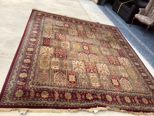 A large traditional Persian area rug with an intricate multi-panel floral layout and a wide red border, completely deep-cleaned, with fully restored pile and neatly aligned, repaired white decorative fringes.