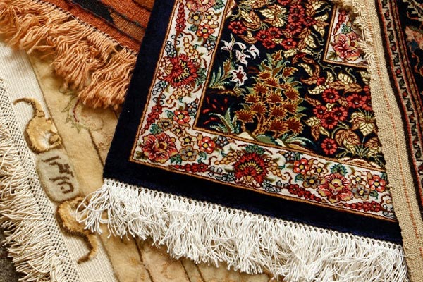 A professional worker repairing rug fringe