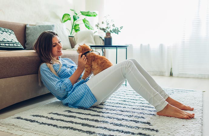 Owner and pet sharing a tender moment on a cozy rug.