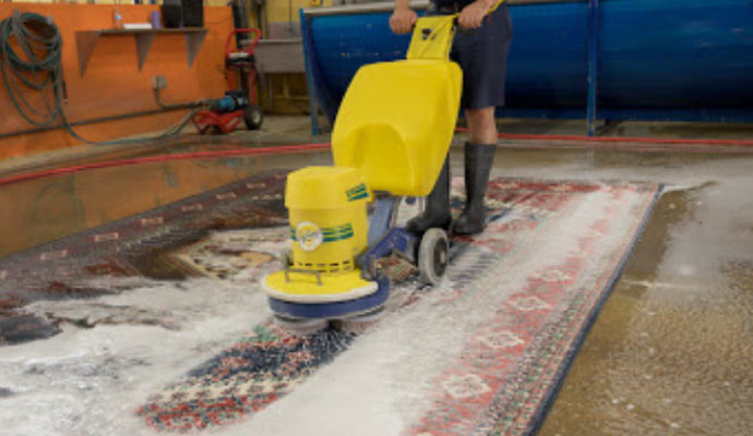 Professional rug cleaning using equipment