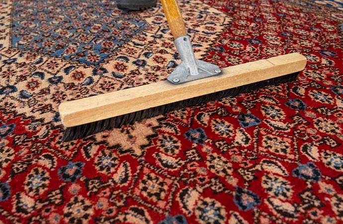 A worker is cleaning the rug