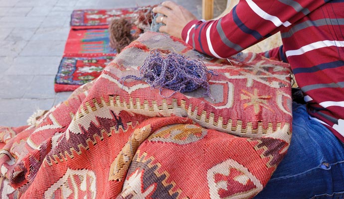 a man repairing rug holes
