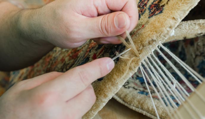 Expert patching a rug