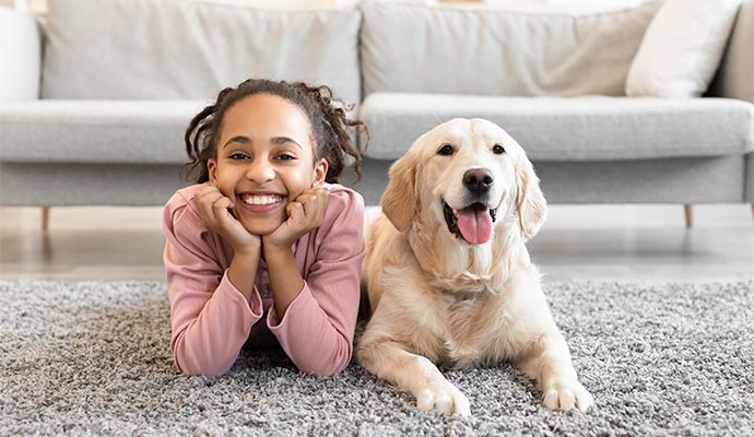 Girl with dog on the carpet