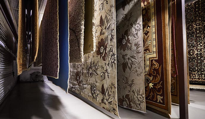 Rows of rugs hanging in a facility for drying