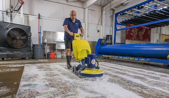 An expert cleaning rug using advanced equipment