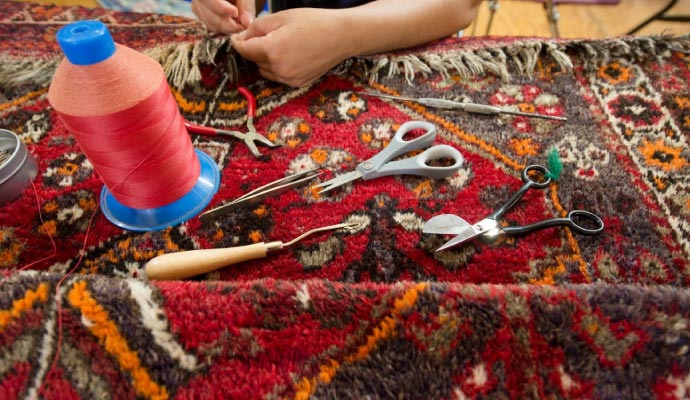 Expert repairing a rug.