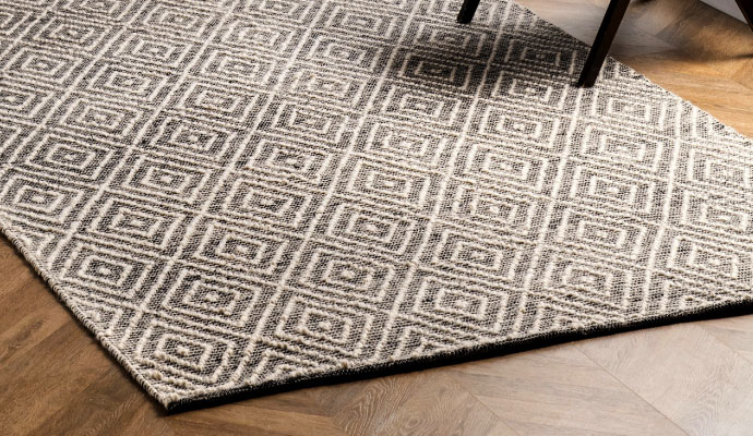 Natural fiber rug on wooden floor