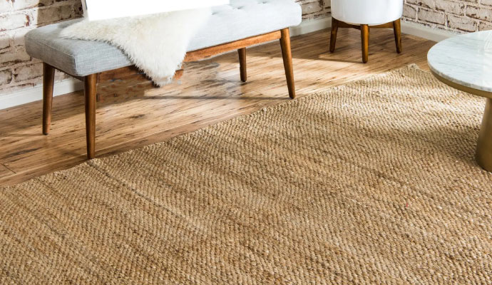 Natural fiber rug placed on wooden floor