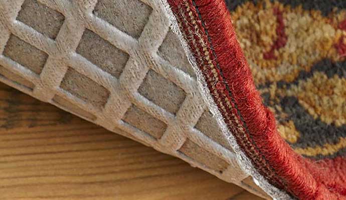 An installed waterproof rug pad